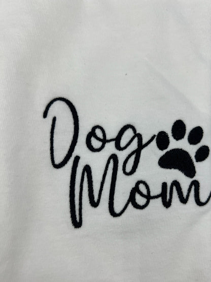 Nannette's Online Designs white cotton t-shirt featuring black embroidered Dog Mom text and a paw print design.