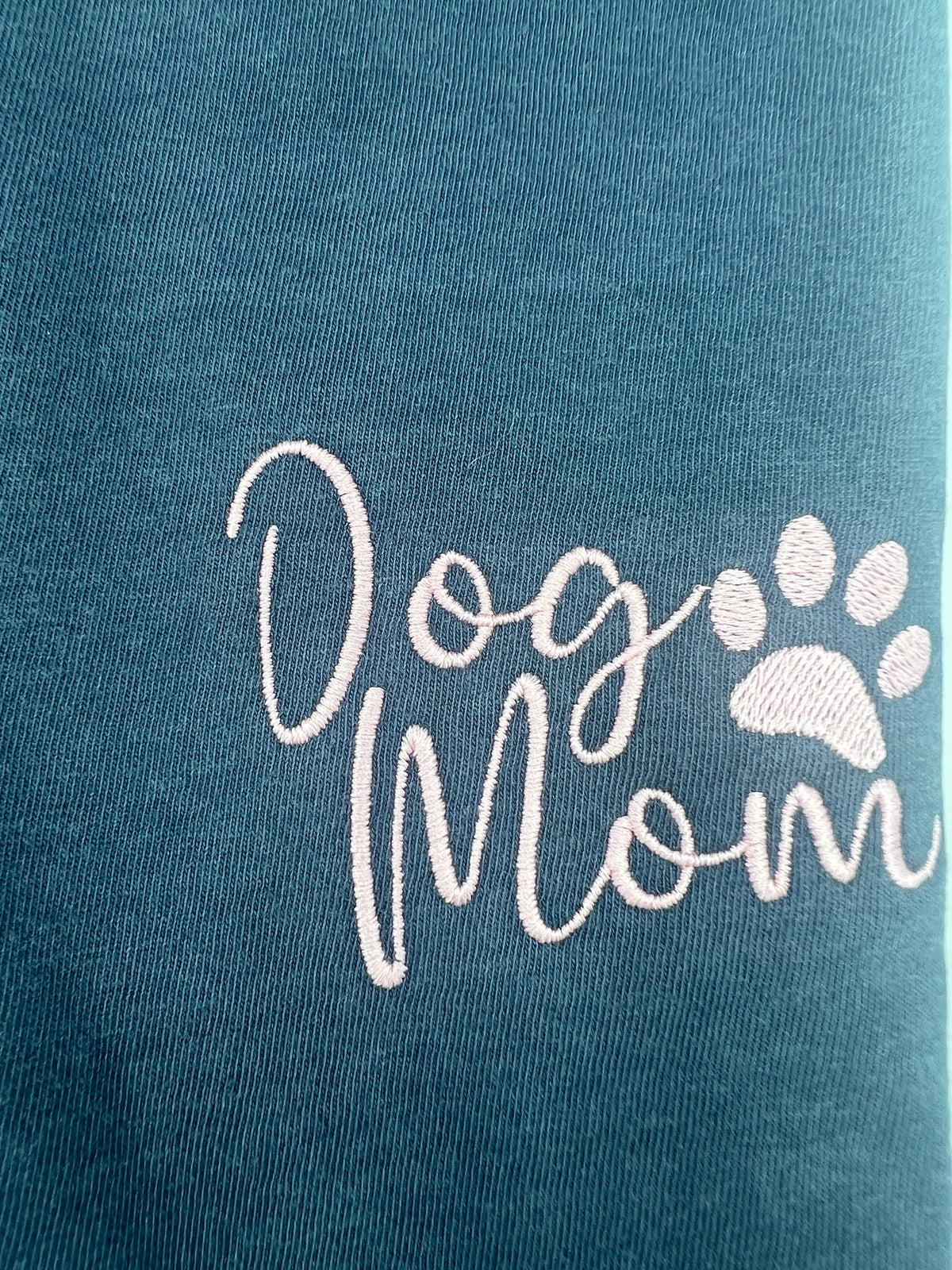 Nannette's Online Designs blue-grey cotton t-shirt featuring elegant pink embroidered Dog Mom text and a paw print.