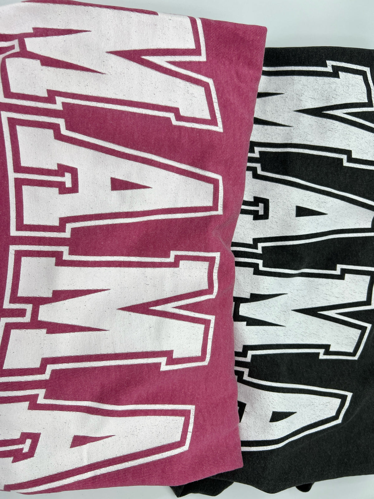 Nannette's Online Designs Mama graphic crewneck t-shirts in maroon and black with white collegiate-style lettering.