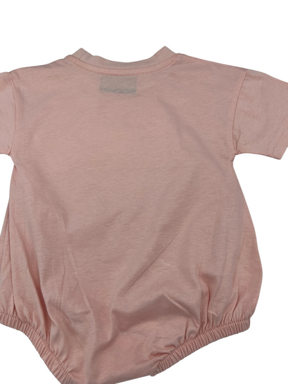 Back view of a Nannette's Online Designs pastel pink infant bubble romper with short sleeves and elasticized legs.