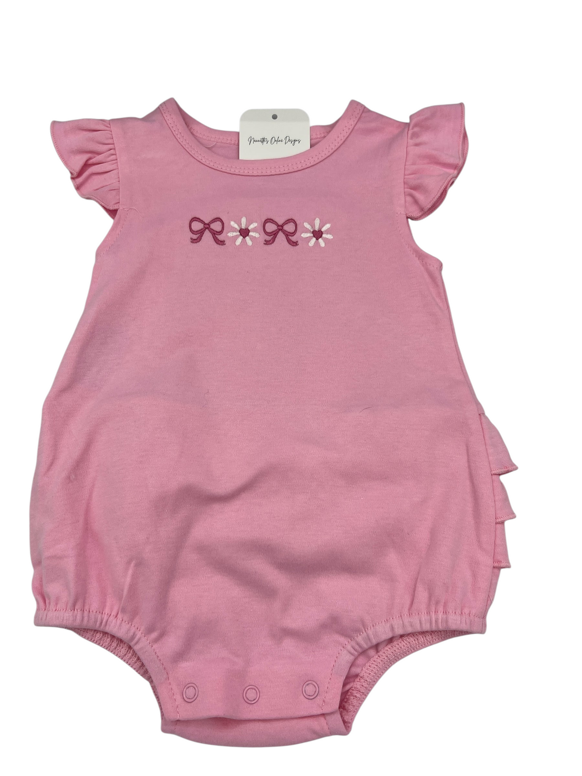 Nannette's Online Designs pink infant bubble romper with ruffle sleeves, bow and flower embroidery, and bottom snaps.
