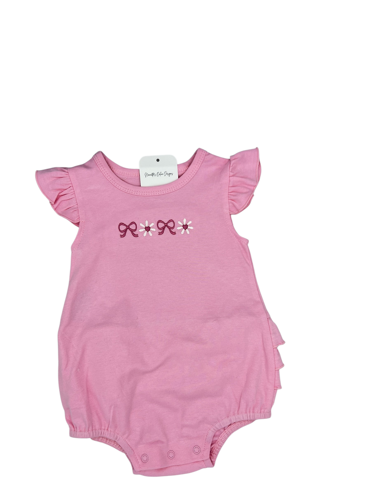 Nannette's Online Designs pink infant bubble romper with ruffle sleeves and embroidered bow and flower details.