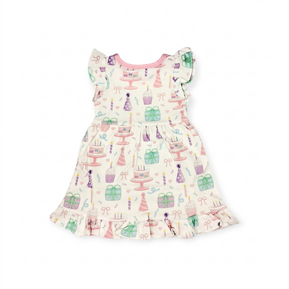 Nannette's Online Designs toddler birthday dress with pastel cake, cupcake, and gift print, flutter sleeves, and ruffles