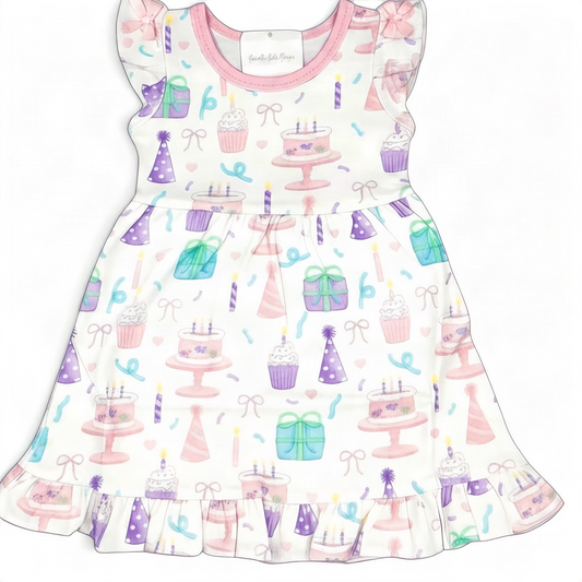 Nannette's Online Designs toddler birthday dress with pastel cake, cupcake, and gift print, flutter sleeves, and ruffles