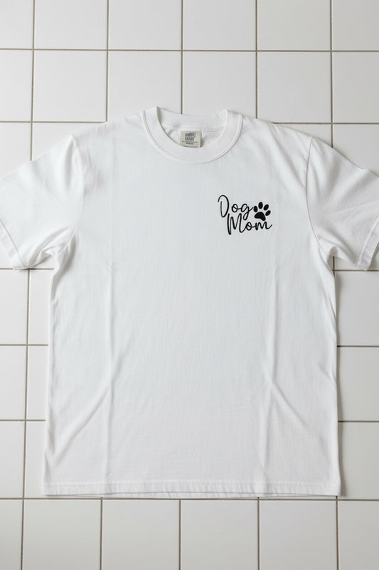 Nannette's Online Designs white cotton t-shirt featuring minimalist black Dog Mom embroidery with a paw print.